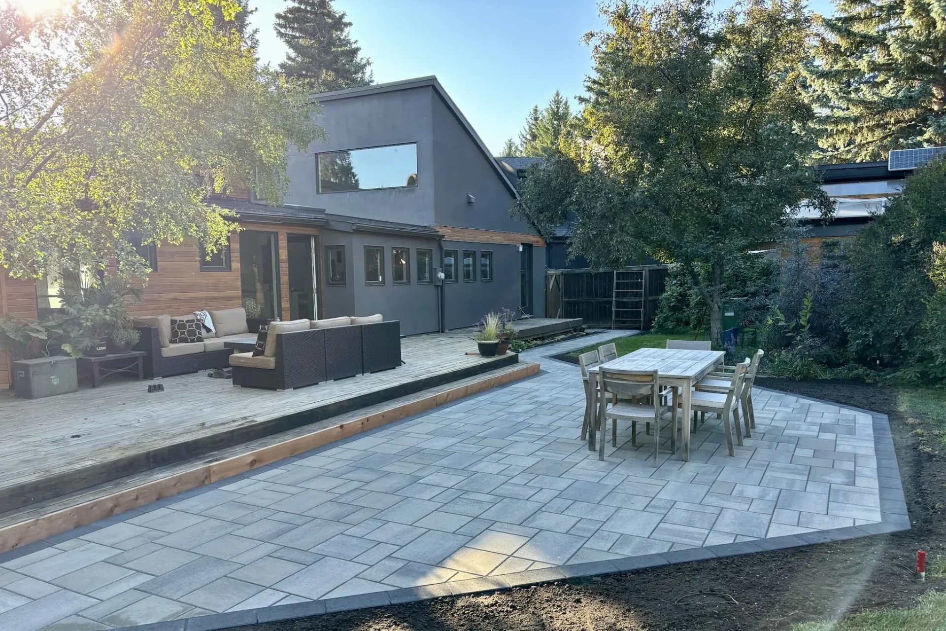 All The Moore Landscaping crew member operating cement mixer during a full-yard paver construction project in Calgary