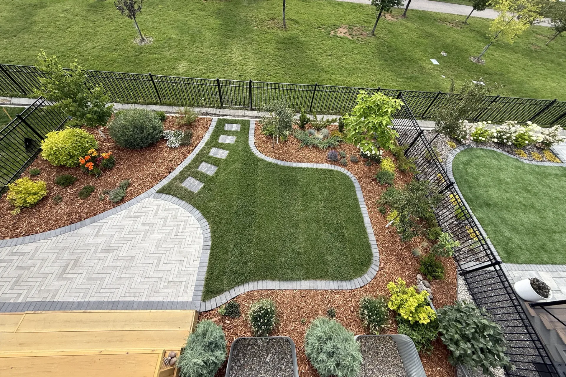 Expansive interlocking paver patio and cedar deck with outdoor dining and lounge area, Calgary landscaping by All The Moore